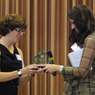 Photo of Debra Johnson giving Amy Swanson her award